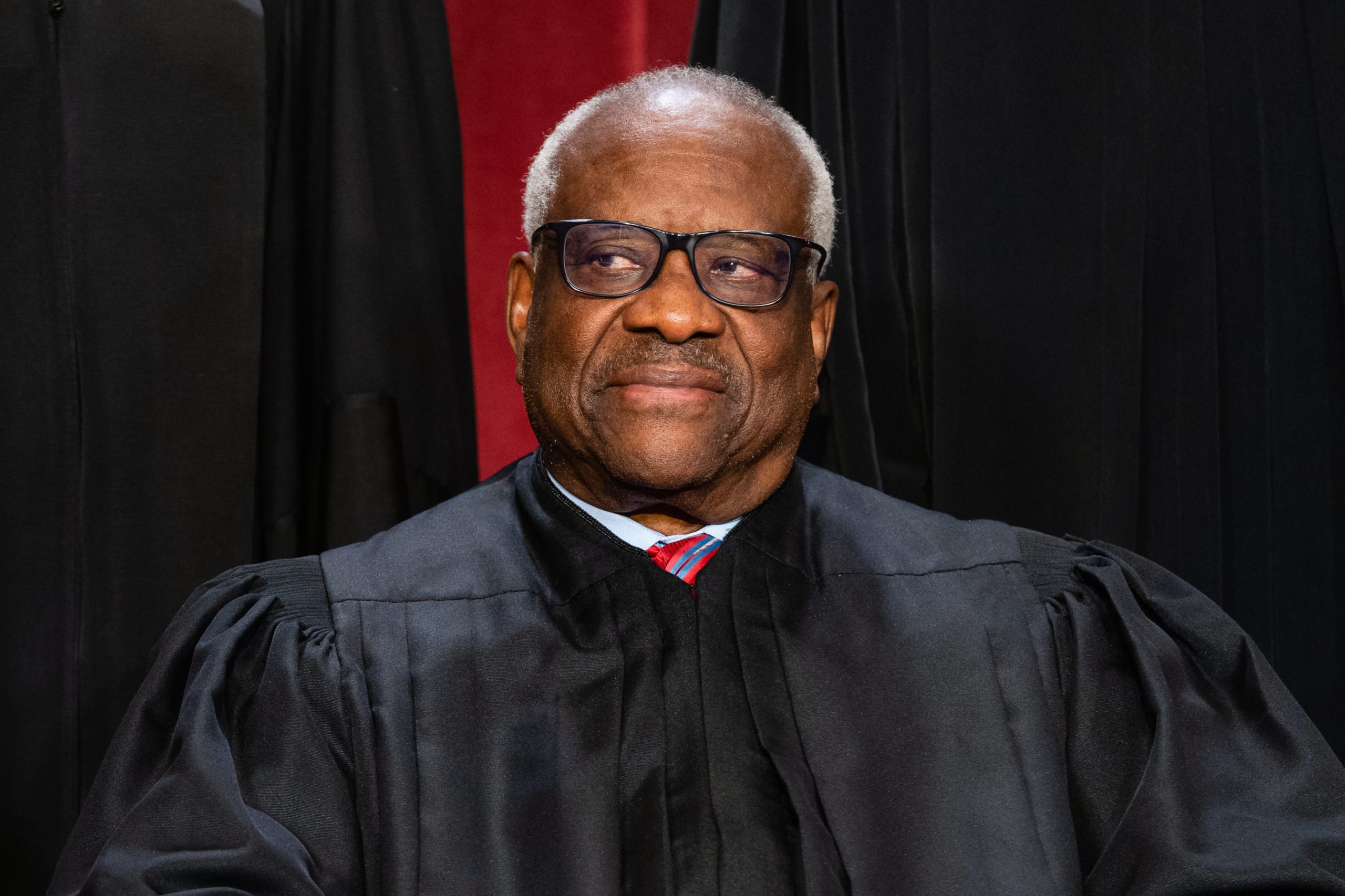 Supreme Court Justice Clarence Thomas in robe, looking to the side during an official portrait session