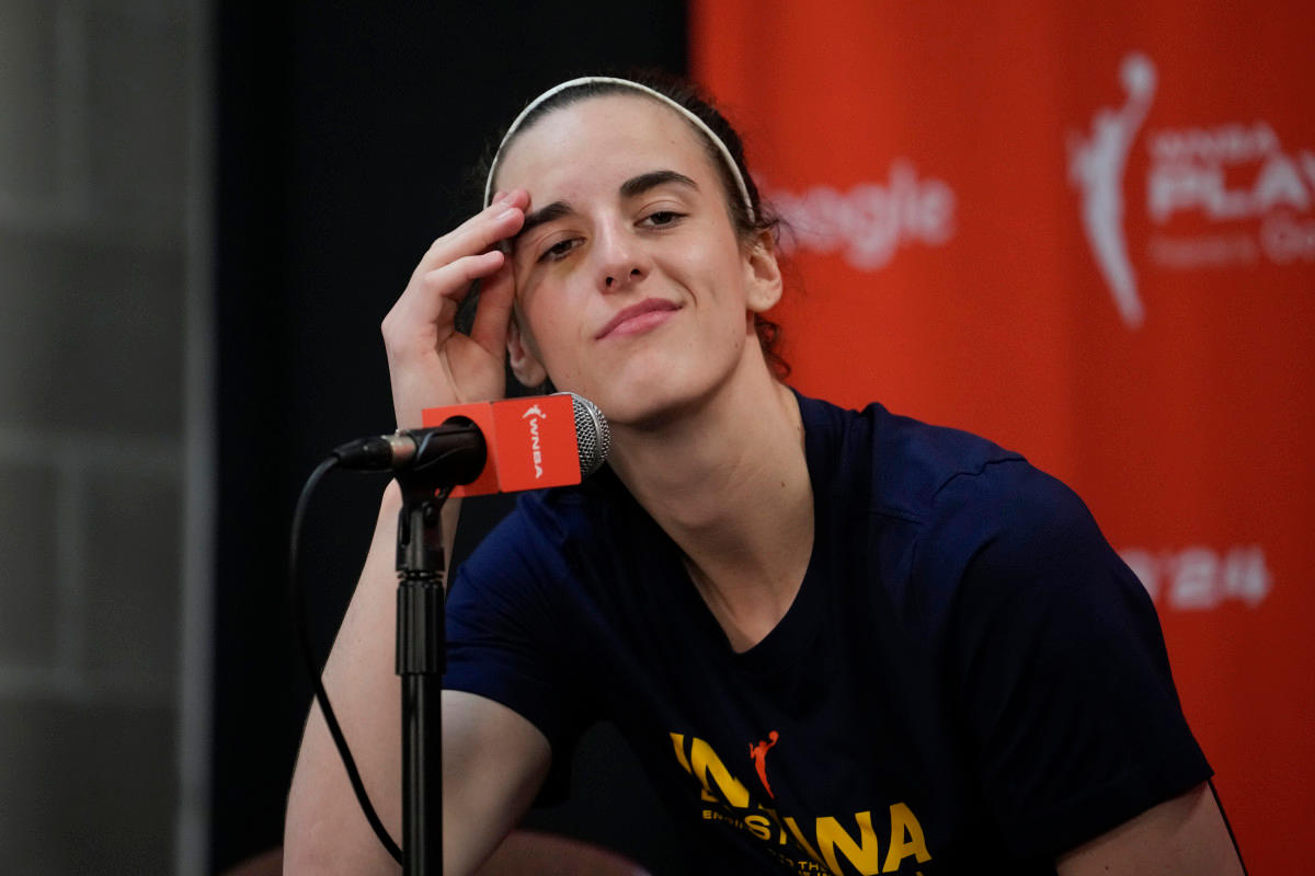 Caitlin Clark smirks at microphone during postgame press conference