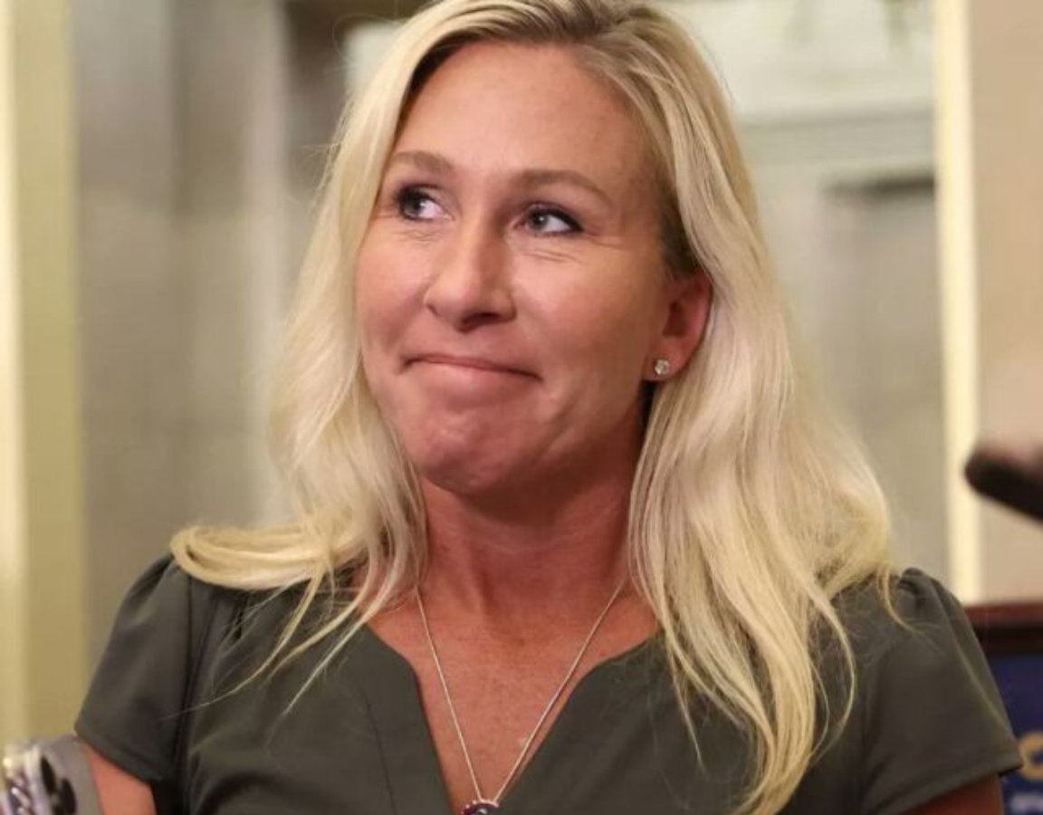 Marjorie Taylor Greene shrugging during press interview