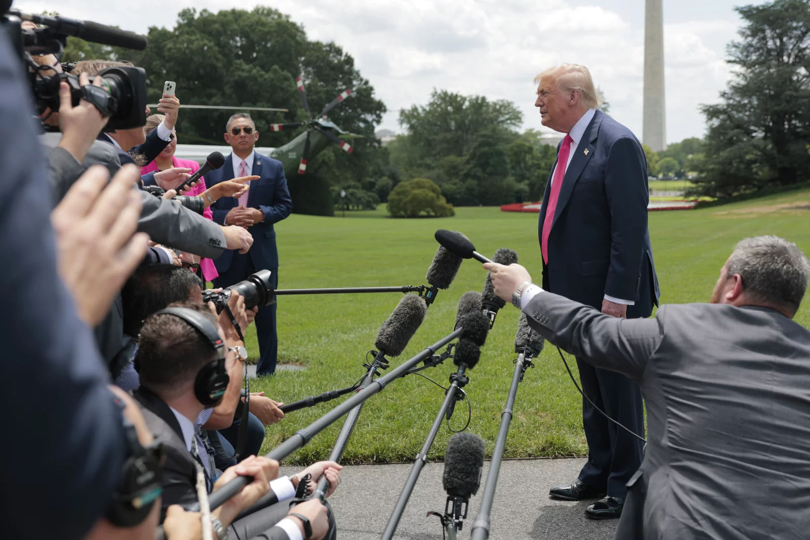 President Trump speaks to reporters on White House lawn with Marine One in background