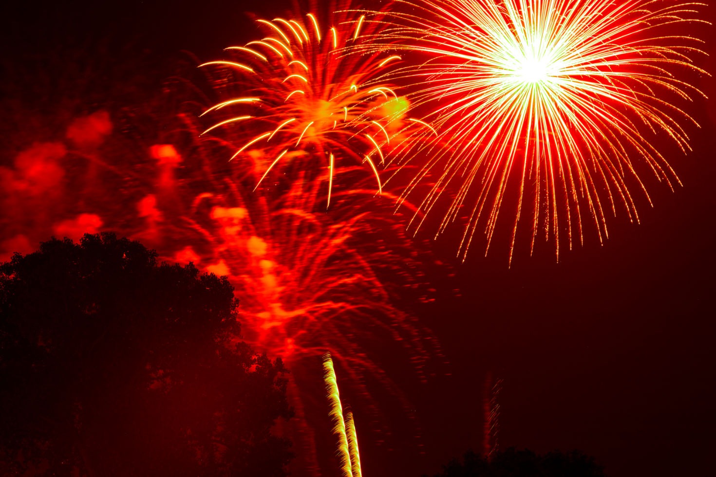 Fireworks exploding in a dry suburban neighborhood