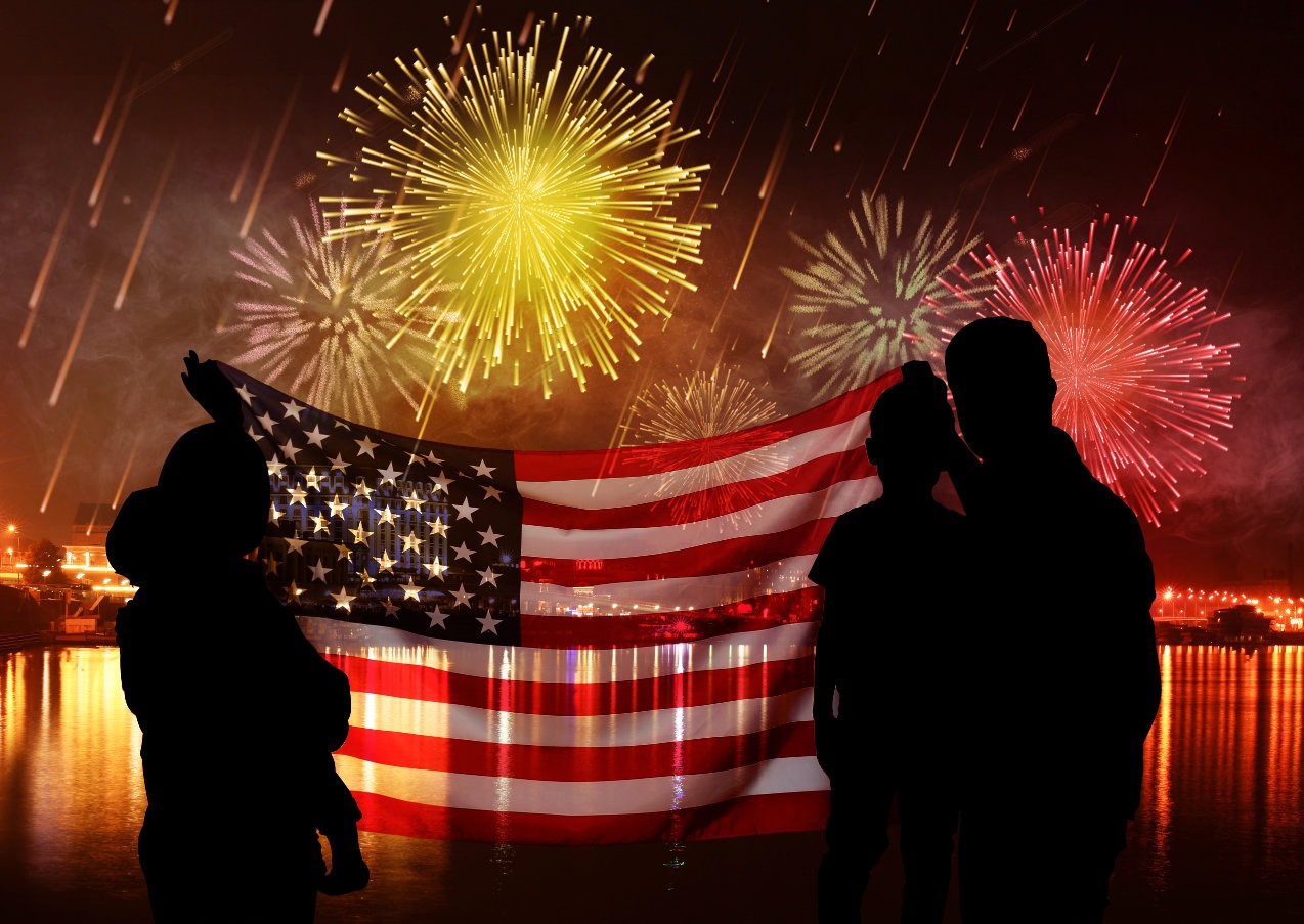 Shirtless suburban dad enjoying fireworks in backyard