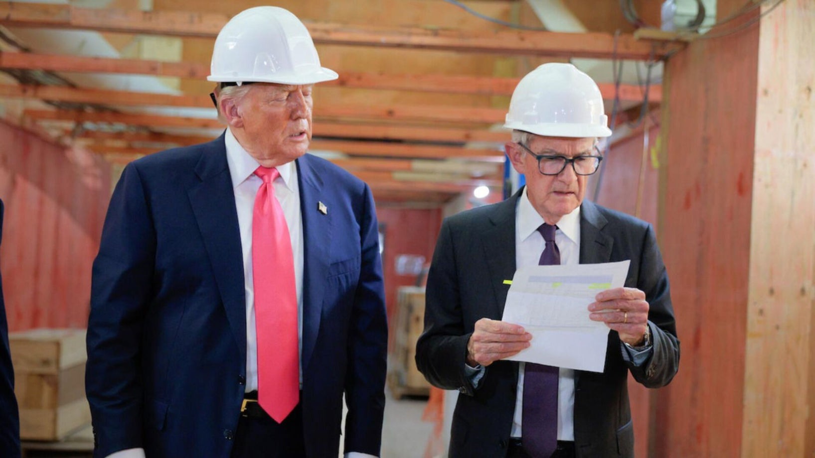 Donald Trump and Jerome Powell in hard hats at Federal Reserve construction site