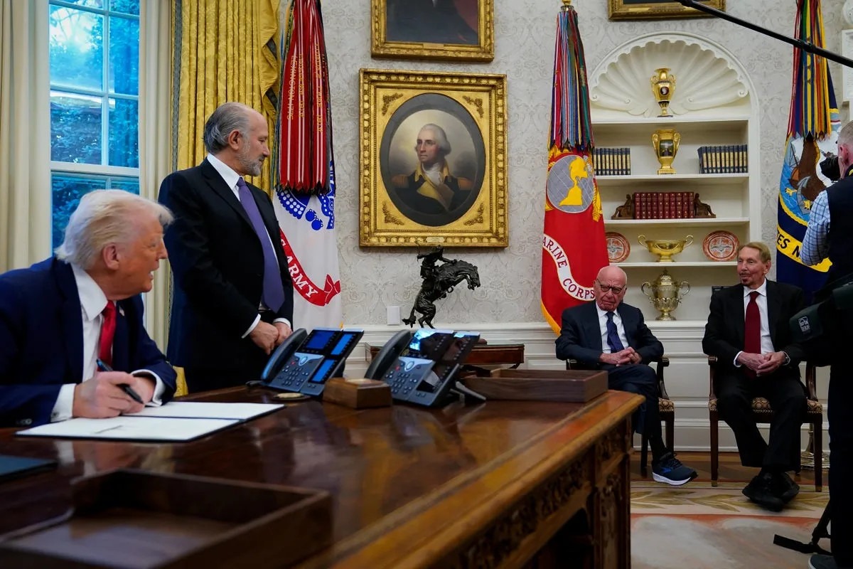 Donald Trump sits at Oval Office desk with Rupert Murdoch and executives