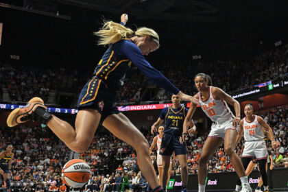 Indiana Fever player attempts to save the ball during a game against the Connecticut Sun