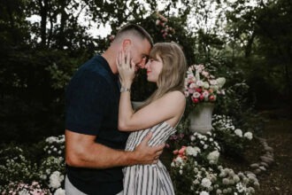 Taylor Swift and Travis Kelce embracing in a garden after engagement
