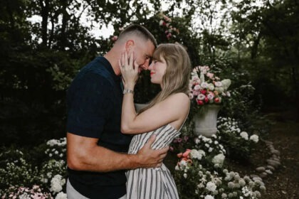 Taylor Swift and Travis Kelce embracing in a garden after engagement