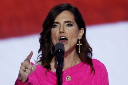 Nancy Mace speaking passionately into a microphone during a political event