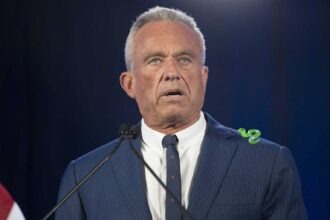 Robert F. Kennedy Jr. speaking at a podium during campaign event