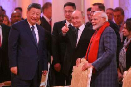 Xi Jinping, Vladimir Putin, and Narendra Modi smiling and talking at the Shanghai Cooperation Organization summit