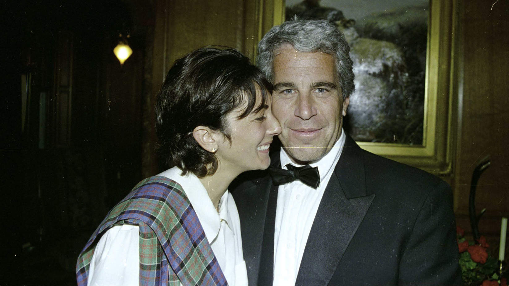 Ghislaine Maxwell smiling with Jeffrey Epstein at a formal event