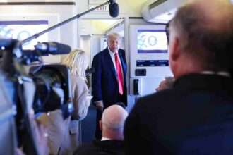 Donald Trump speaks to reporters aboard Air Force One.