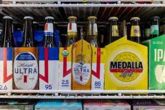 Michelob Ultra and Modelo beer packages inside a store refrigerator