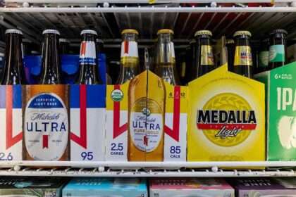 Michelob Ultra and Modelo beer packages inside a store refrigerator