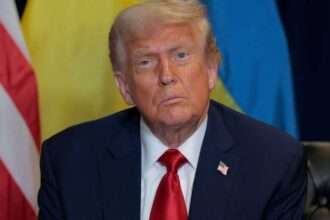 Donald Trump at press conference with American and Ukrainian flags behind him