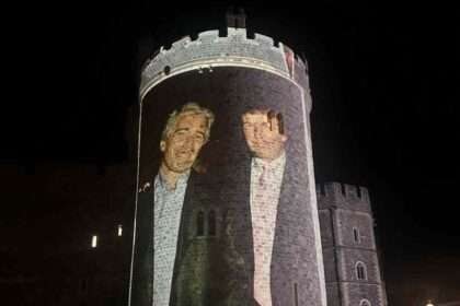 Large protest projection of Trump and Epstein onto Windsor Castle tower at night