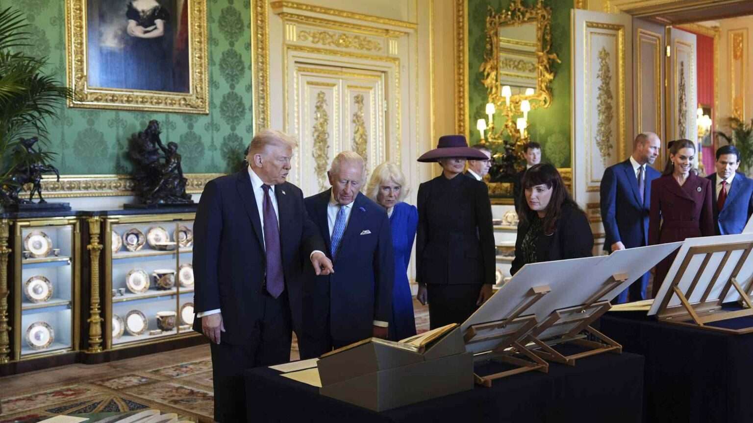 Donald Trump with King Charles III and Queen Camilla viewing royal items at Windsor Castle