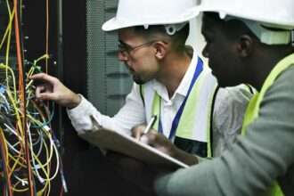 Technicians working to repair a server rack during a major outage.