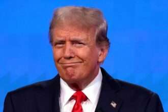 Donald Trump smirking during a press conference