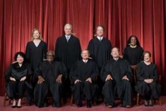 Supreme Court justices posing for official photo in robes.