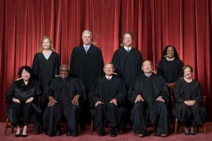 Supreme Court justices posing for official photo in robes.