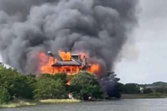 Large house engulfed in flames and heavy black smoke on Edisto Beach, South Carolina