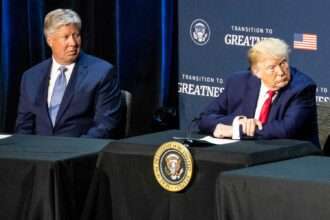 Donald Trump sits beside pastor Robert Morris during a Texas roundtable event.