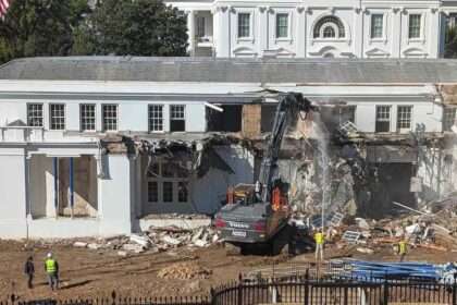 Construction machinery demolishing part of the White House East Wing