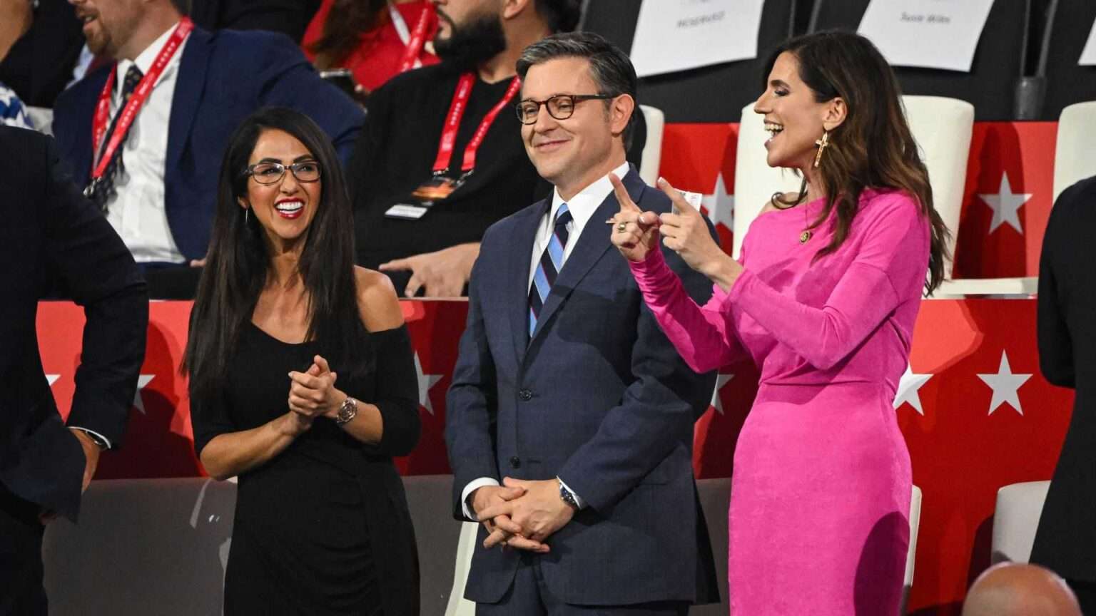 Lauren Boebert, Mike Johnson, and Nancy Mace standing together at a political event, smiling and talking in the audience.