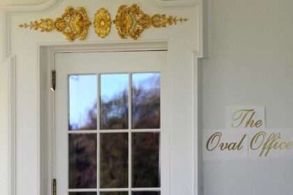 President Trump’s gold “Oval Office” sign mounted outside the White House office door
