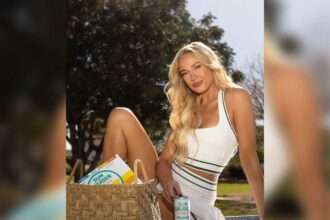 Sophie Cunningham sitting outdoors at a picnic table holding a Sun Cruiser canned cocktail.