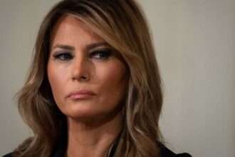 Close-up portrait of Melania Trump looking serious during a public appearance.
