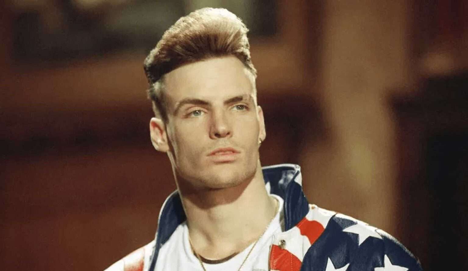 Vanilla Ice wearing a stars and stripes jacket in a promotional portrait.
