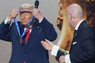 Donald Trump receiving the FIFA Peace Prize medal from Gianni Infantino during a public ceremony