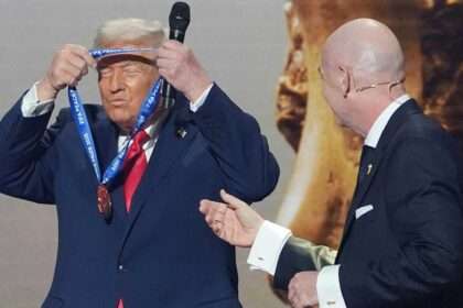 Donald Trump receiving the FIFA Peace Prize medal from Gianni Infantino during a public ceremony